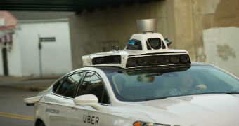 A car with self-driving sensors on the roof.