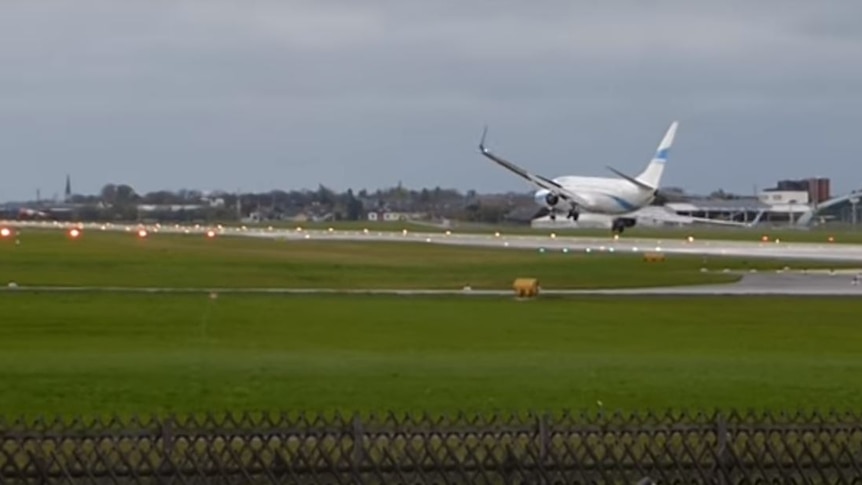 An Enter Air flight leans heavily to the right as it is about to touch down on an airport runway in Salzburg, Austria.