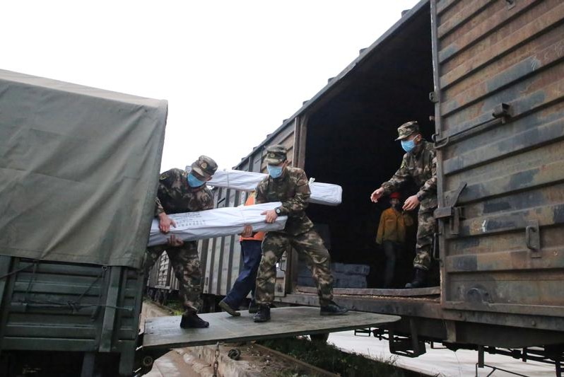 military loading goods on a truck.