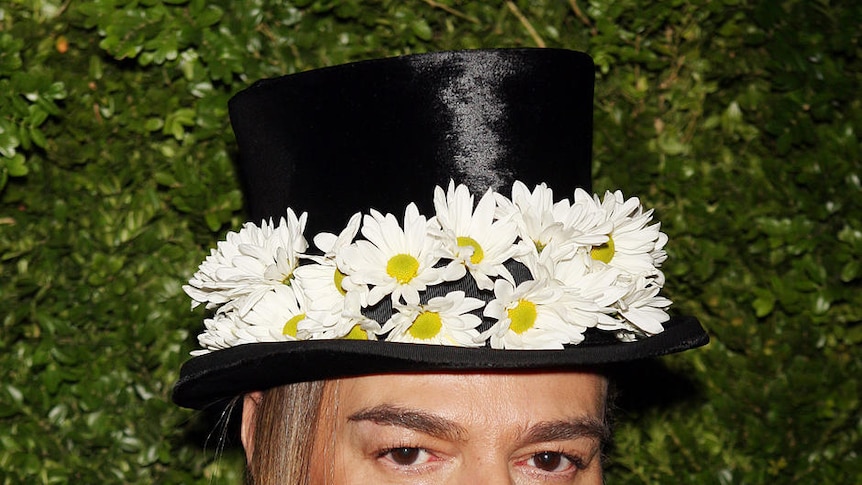 British designer John Galliano poses with a model at the end of
