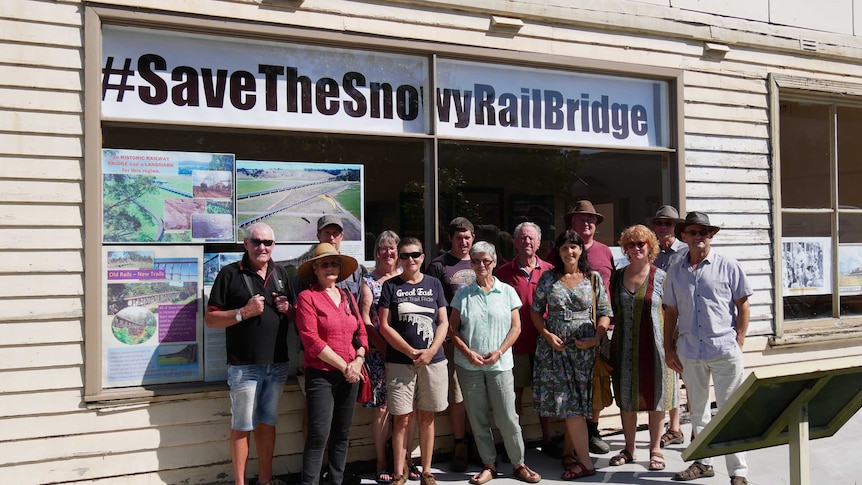 The Save the Snowy Rail Bridge committee members stand outside their newly opened shopfront in Orbost.
