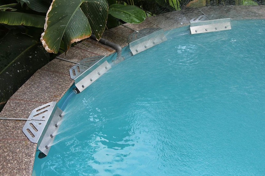 Four Aquasense water pumps attached to the side of Michael Bruvel's pool.