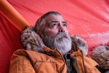 A grizzly George Clooney in arctic weather clothing in the sci-fi movie The Midnight Sky
