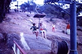 A boy and a woman ride a chair lift