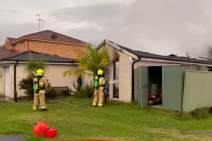 Firefighters put out a fire with a hose
