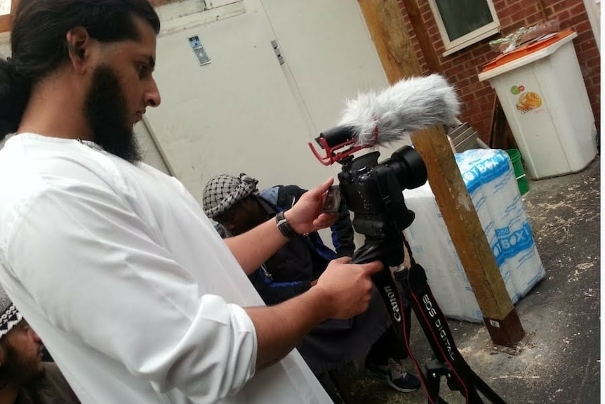 Haseeb Hamayoon adjusts a camera in the backyard of a house in London.