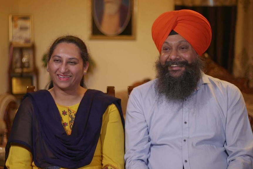 Satinder Pal Kaur and Avtar Singh sitting next to each other in their sofa.
