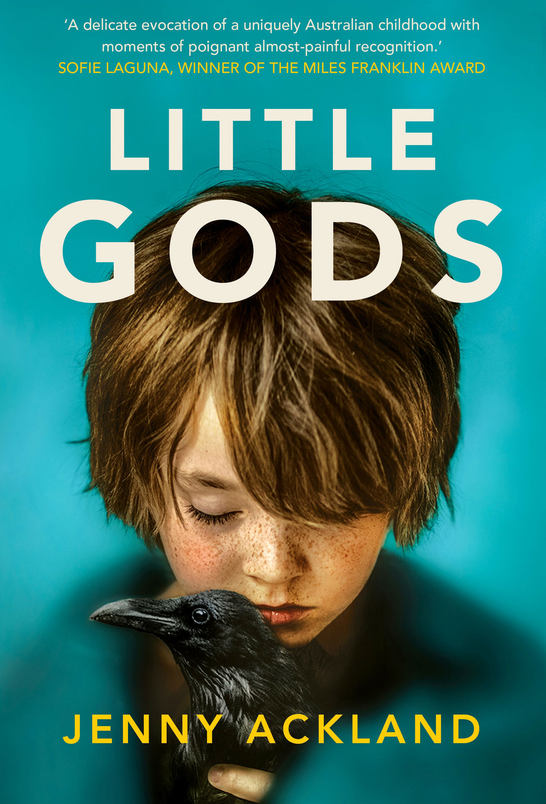 A book cover showing a small child's face bent over a crow that the child is holding in their hands.