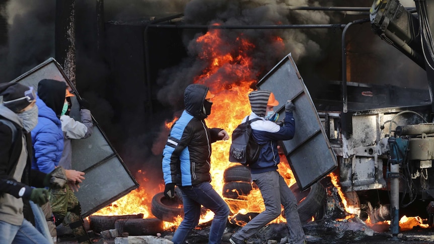 Protestors erect barricades as they clash with police in Kiev.