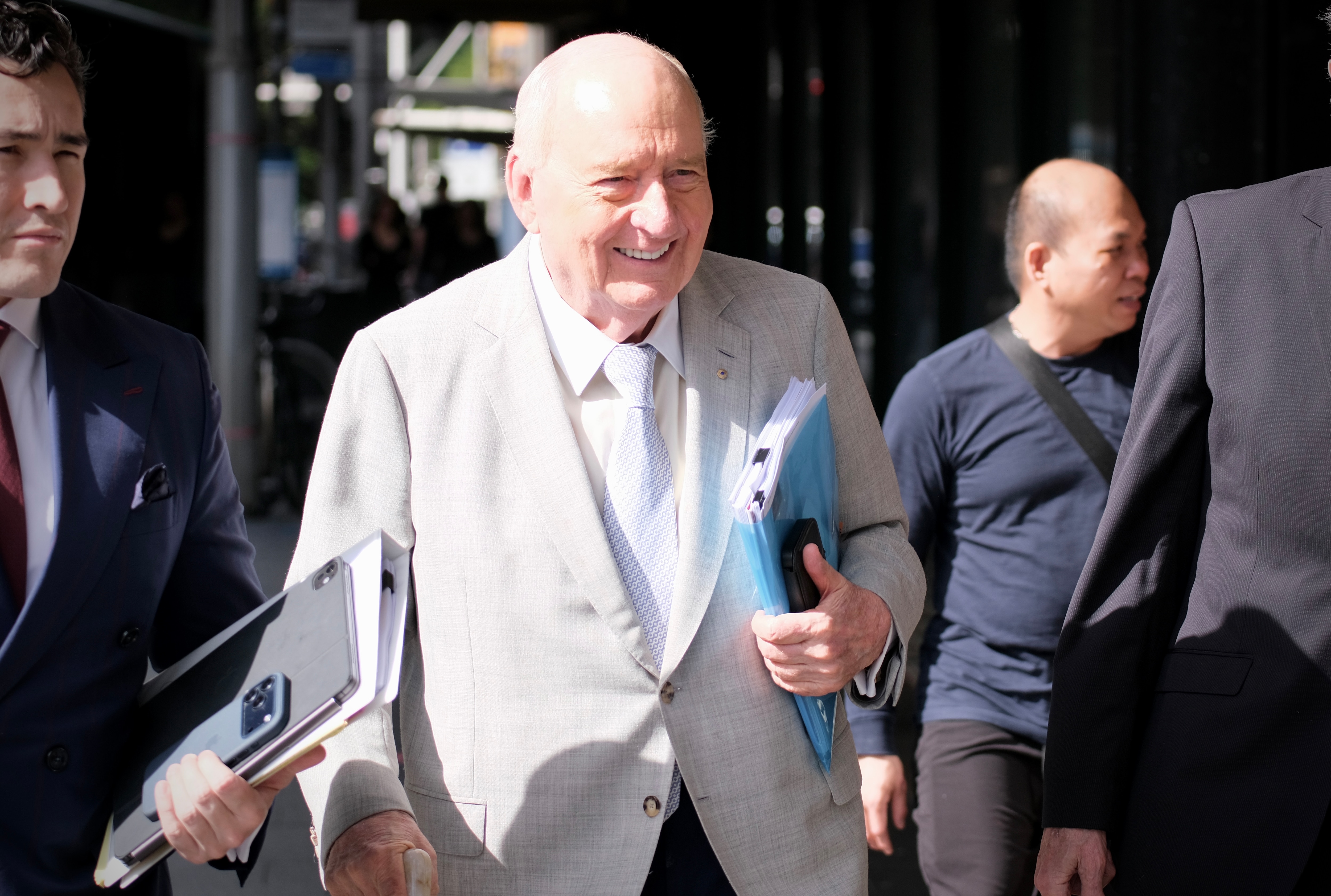 Alan Jones in grey suit and blue tie