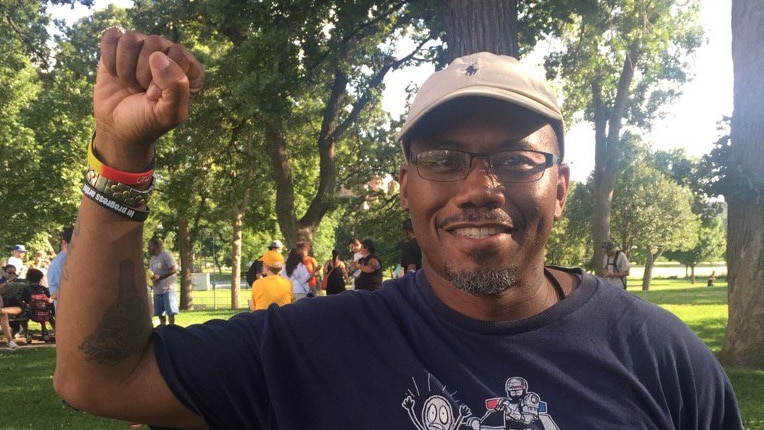 An activist in Minneapolis celebrates after the resignation of Police Chief Janee Harteau.