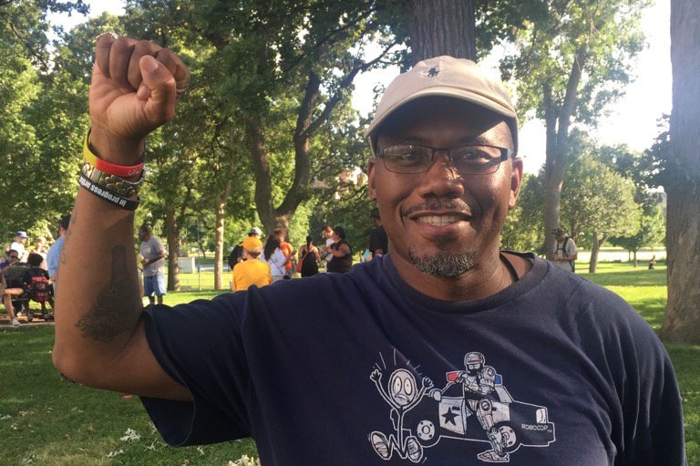 An activist in Minneapolis celebrates after the resignation of Police Chief Janee Harteau.