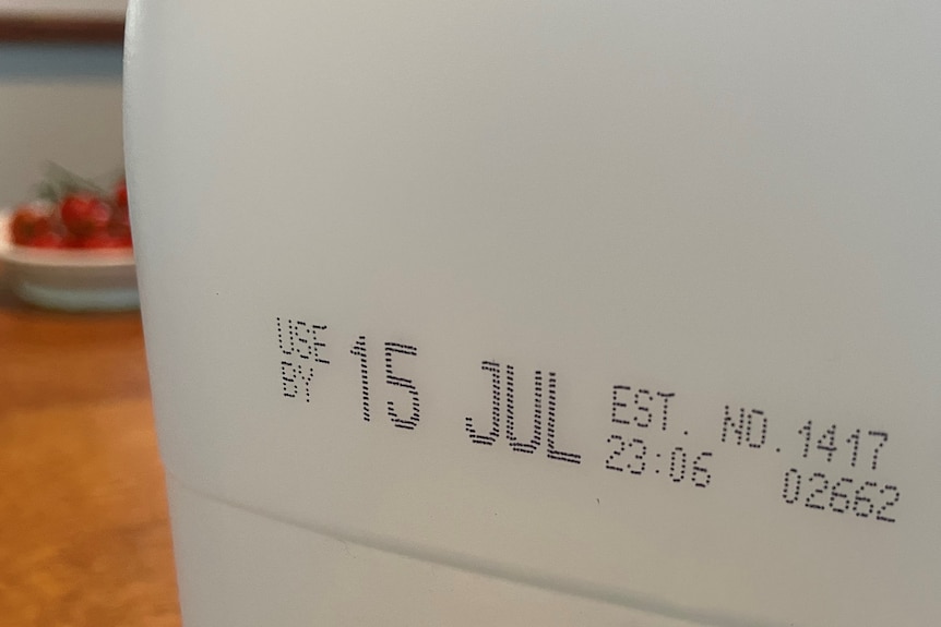 A use-by date on a bottle of milk