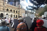 About 200 cab drivers and their supporters rallied outside State Parliament