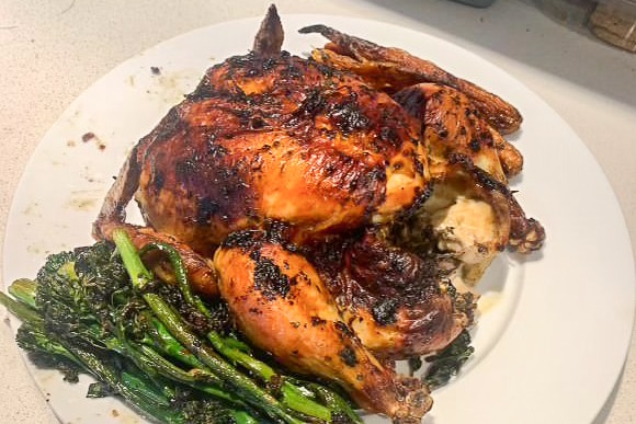 Roasted chicken on a white plate.