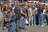 Crowds gather outside a court amid the appearance of the accused cannibals.