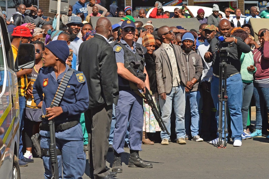 Crowds gather outside a court amid the appearance of the accused cannibals.