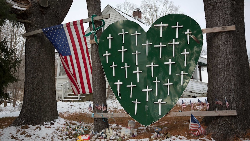 A red heart with white crosses on it as a memorial to shooting victims.