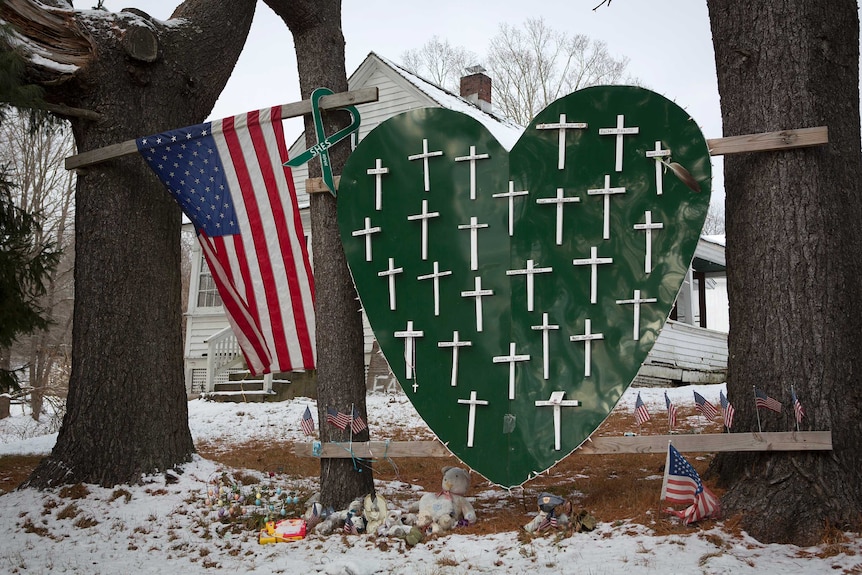 A red heart with white crosses on it as a memorial to shooting victims.