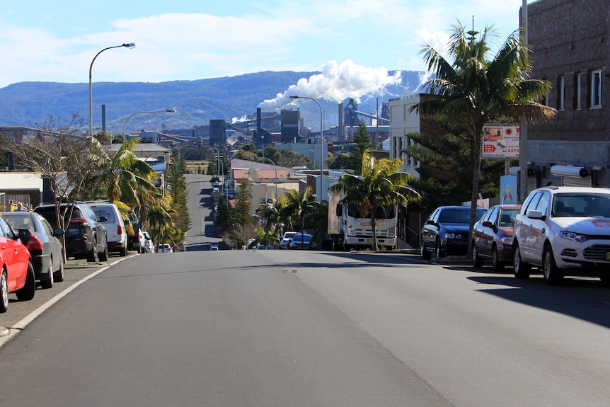 The view looking west along Wentworth Street in Port Kembla with steam billowing from a chimney.