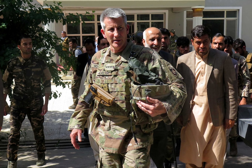 General John Nicholson walking with helmet in hand.