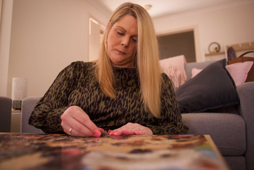A woman works on a jigsaw puzzle