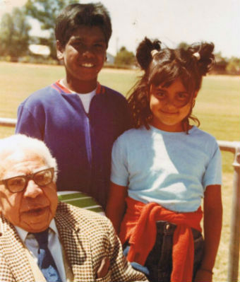 Two children pose with their grandfather