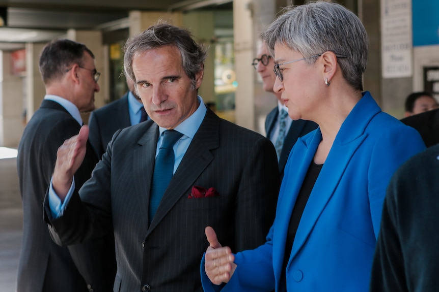 Rafael Grossi and Penny Wong talk outside some shops