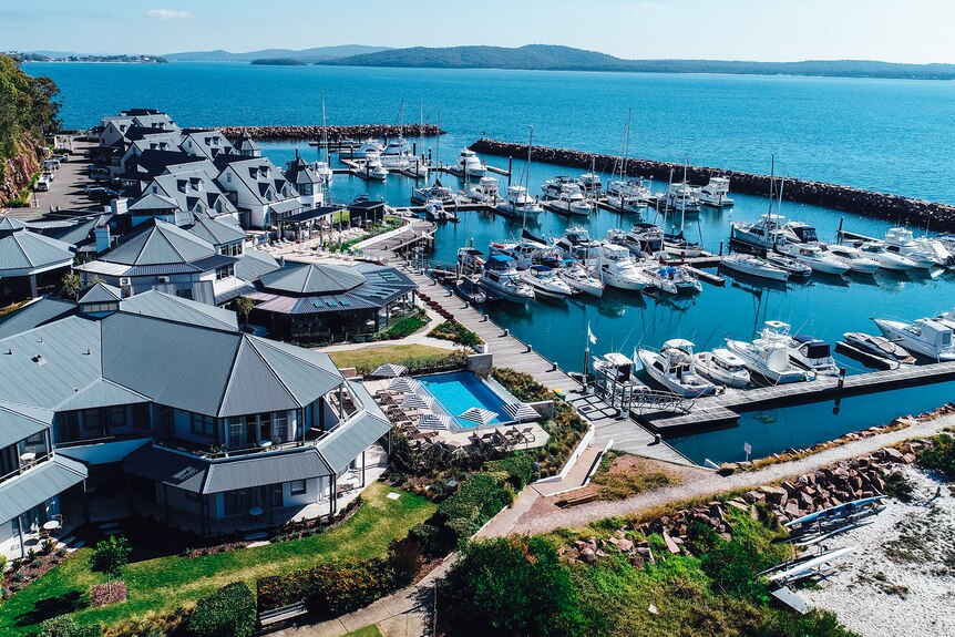 A waterside hotel and restaurant surrounded by boats.