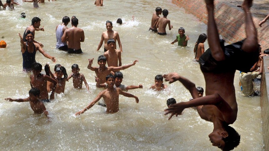 Indian youths cool off in Amritsar as heatwave conditions persist over much of northern India.