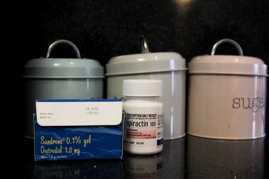 Sandrena gel and Spiractin tablets sitting in front of Emily's tea and coffee tins.