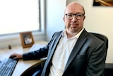 Property analyst Louis Christopher sits at his computer.