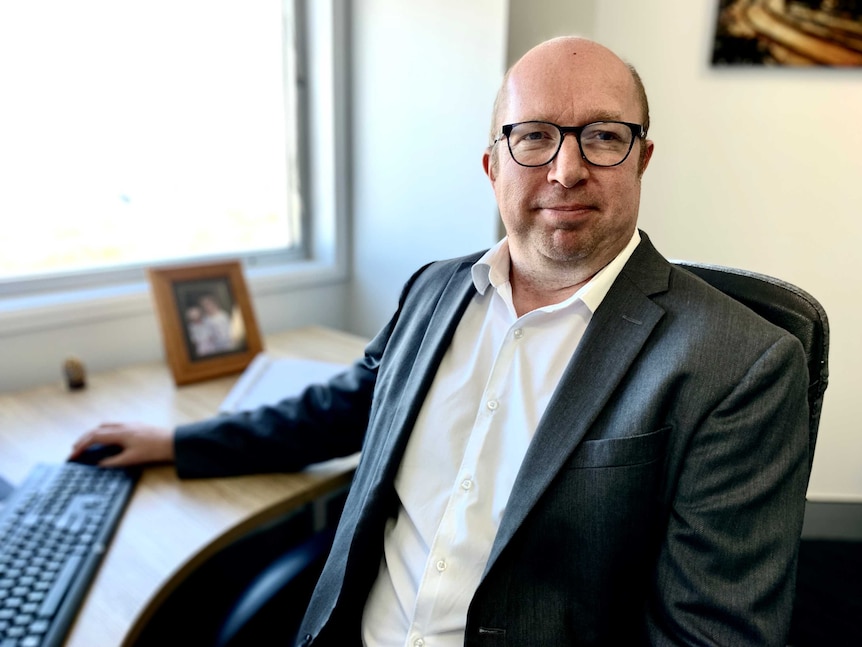 Property analyst Louis Christopher sits at his computer.