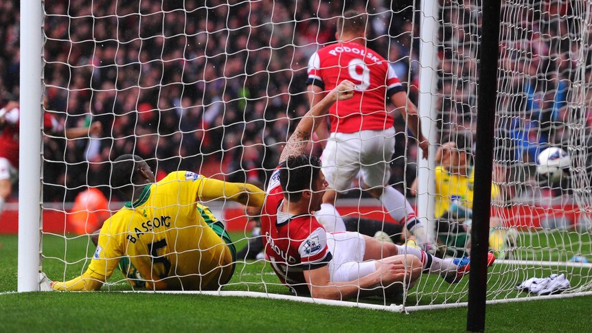 Norwich's Sebastien Bassong scores an own goal against Arsenal.