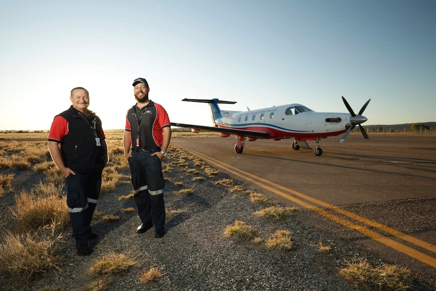 two men in front of rfds plane