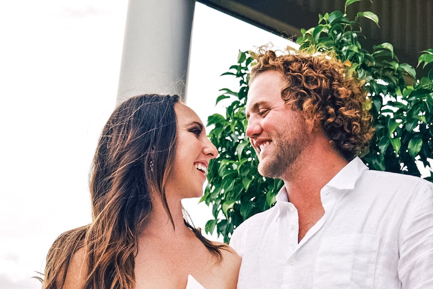 A man and woman look happily into each other's eyes