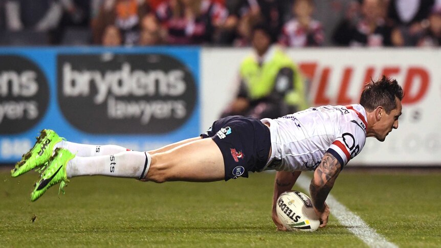 Mitchell Pearce of the Roosters scores a try against Wests Tigers at Campbelltown on June 11, 2017.