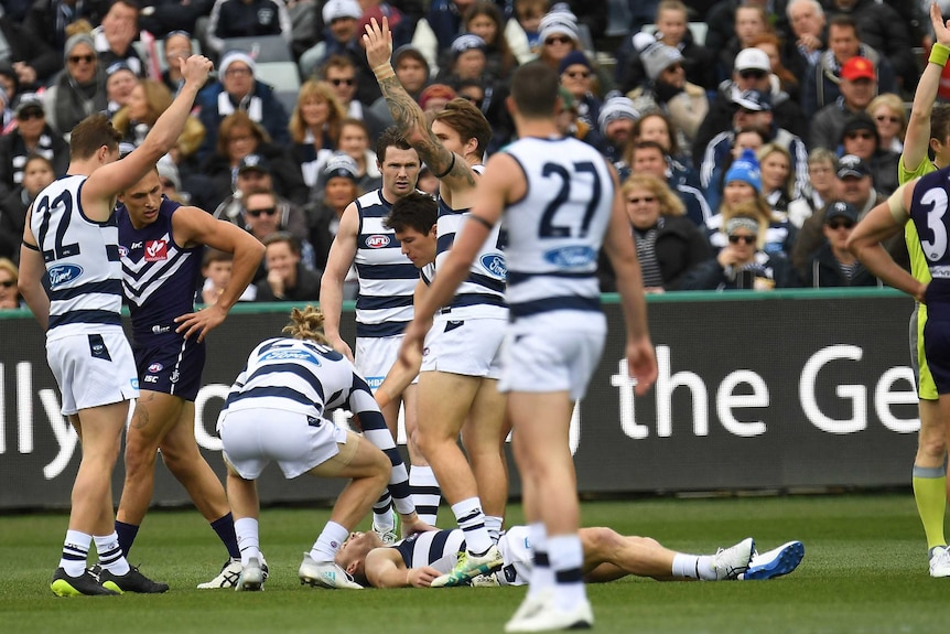 Joel Selwood of the Cats lies on the ground after being knocked unconscious against Fremantle.