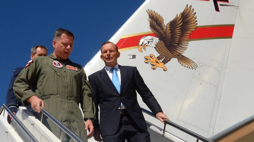 Tony Abbott speaks with with aircraft commander Bill Pennington after inspecting the new P-8a Poseidon maritime aircraft.
