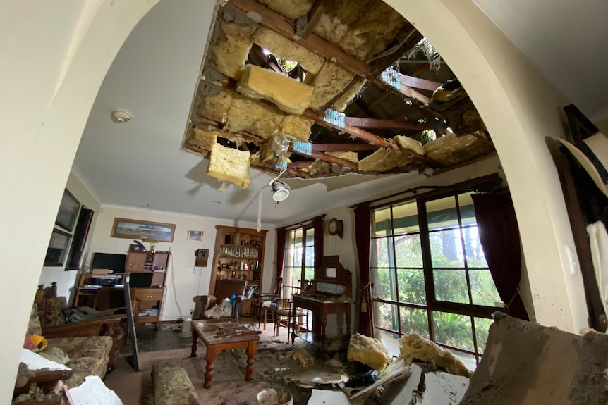 A partially destroyed ceiling, photographed from inside the home.