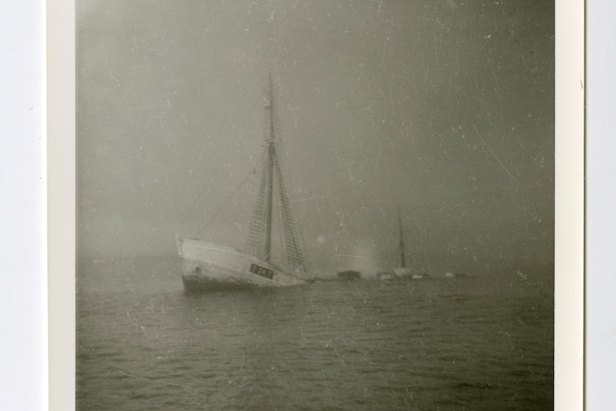 Black and white image of a sinking ship. 