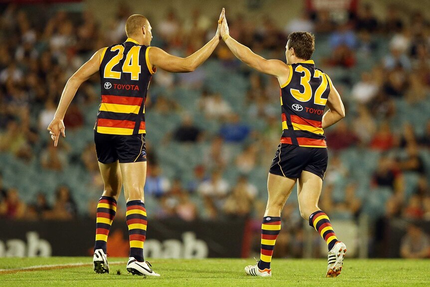 Sam Jacobs and Patrick Dangerfield celebrate a goal for the Crows against Carlton at Football Park.