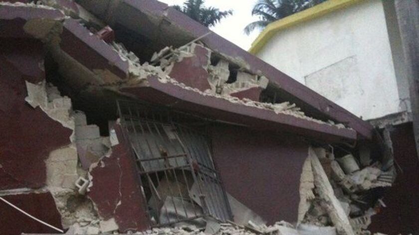 A local walks past a devastated building in Haiti's capital Port-Au-Prince