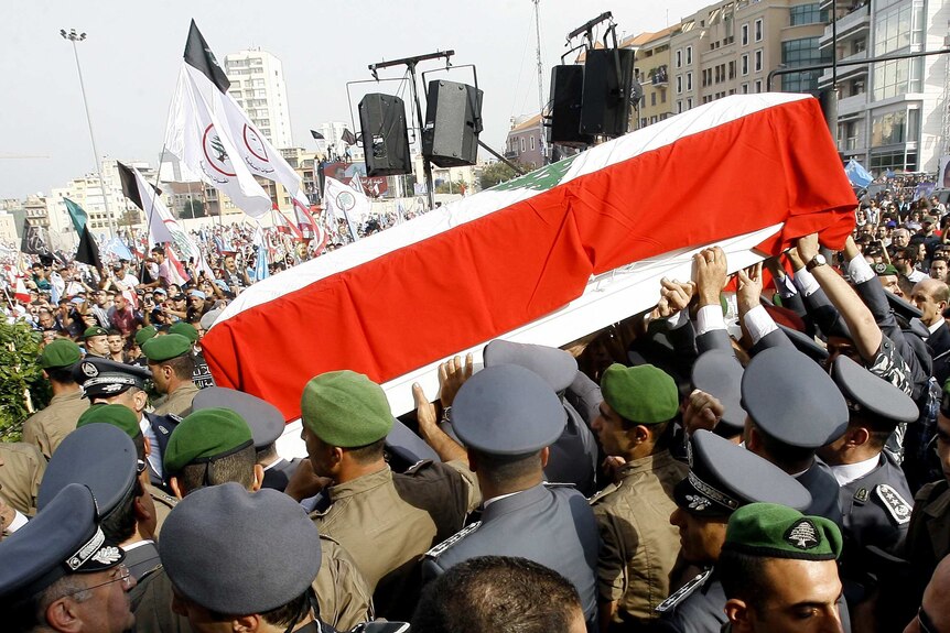 Lebanese officers of Internal Security Forces carry the coffin of  General Wissam al-Hassan.