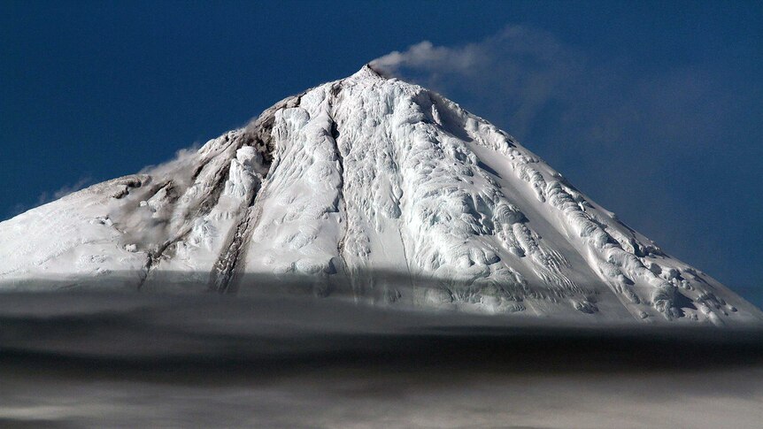 A picture of a snow-capped mountain set against a blue sky