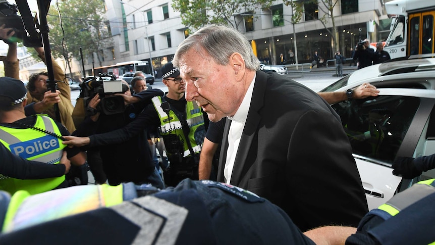 Cardinal George Pell getting out of his car outside the Melbourne Magistrates' Court.