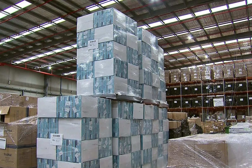 A large tower of boxes in a warehouse.