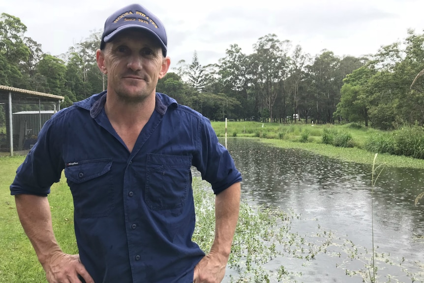 Darren Knowles standing in front of the breeding pond, hands on hips.