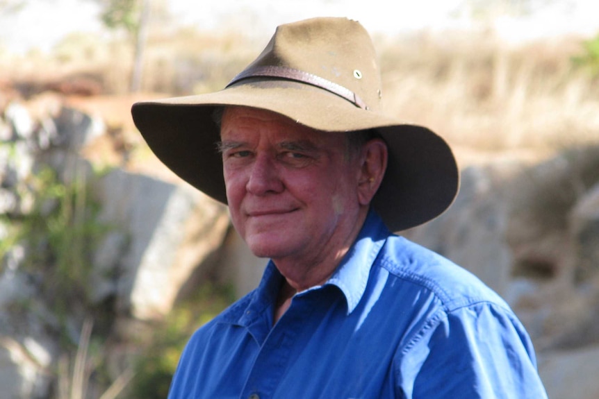 Mid shot of man facing the camera, wearing a hat.