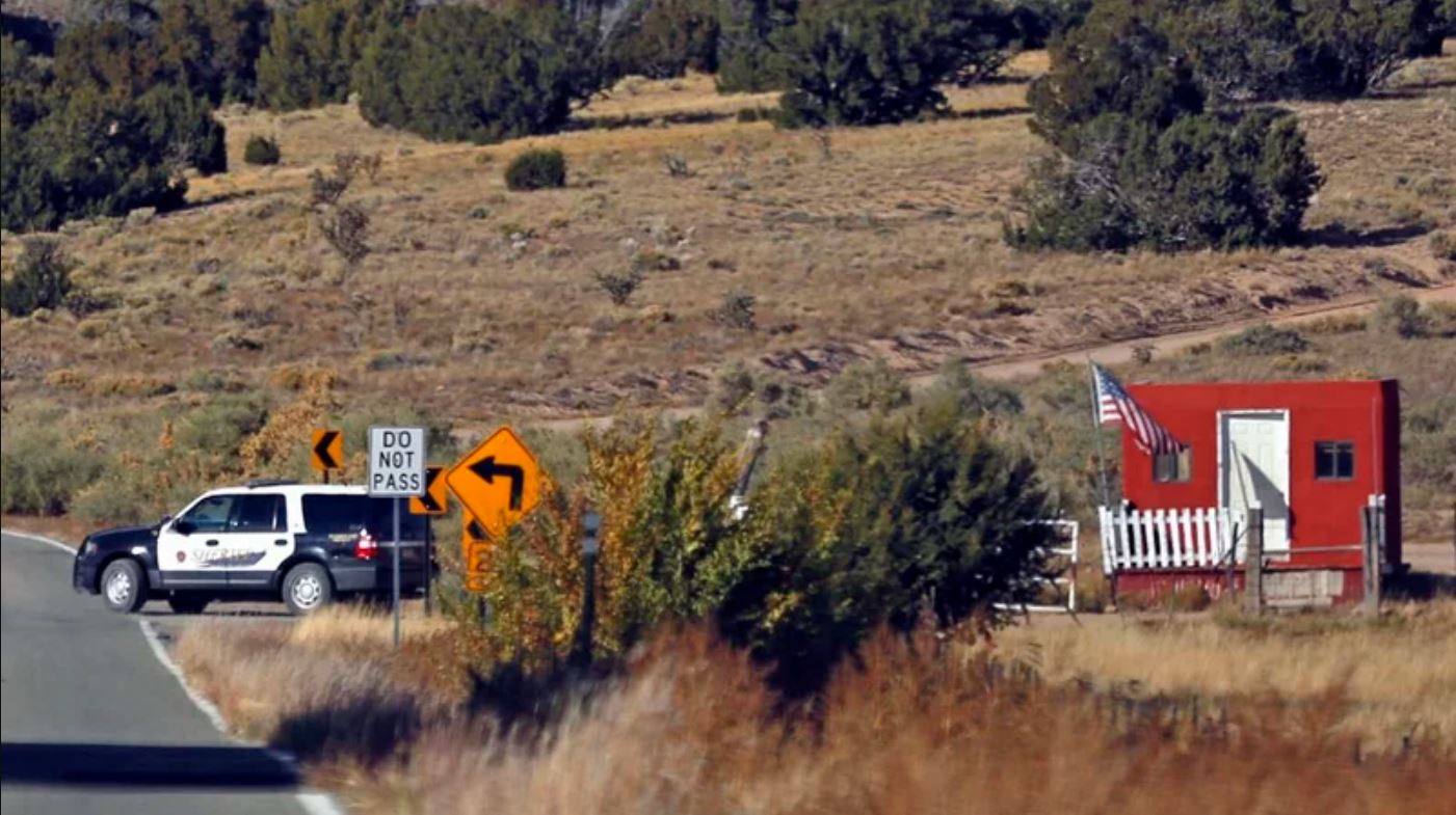 A police car blocks a road.